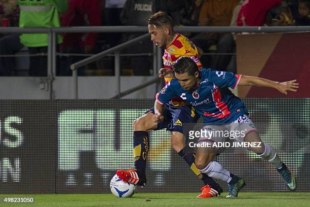 Mauro Cejas of Morelia vies for the ball with Jesus Paganoni of Veracruz, during their Mexican Apertura 2015 tournament football match, at the Jose...