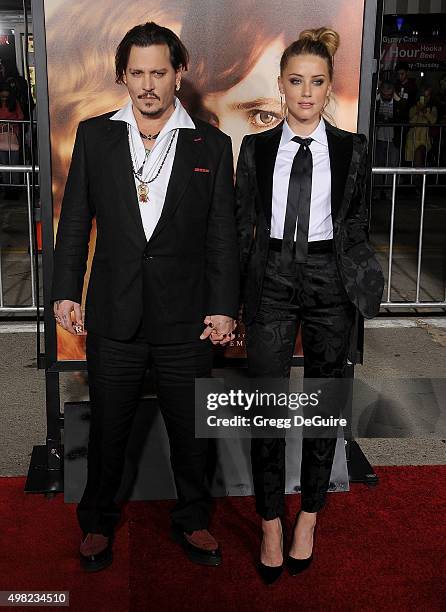 Actors Johnny Depp and Amber Heard arrive at the premiere of Focus Features' "The Danish Girl" at Westwood Village Theatre on November 21, 2015 in...