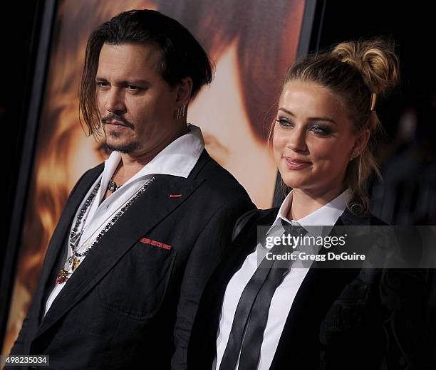 Actors Johnny Depp and Amber Heard arrive at the premiere of Focus Features' "The Danish Girl" at Westwood Village Theatre on November 21, 2015 in...