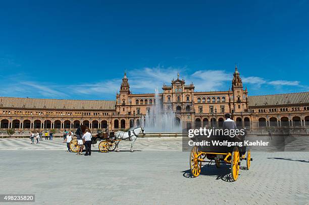 Horse carriage in front of the fountain in the center of the Plaza de Espana built for the Ibero-American Exposition of 1929 was a world's fair held...