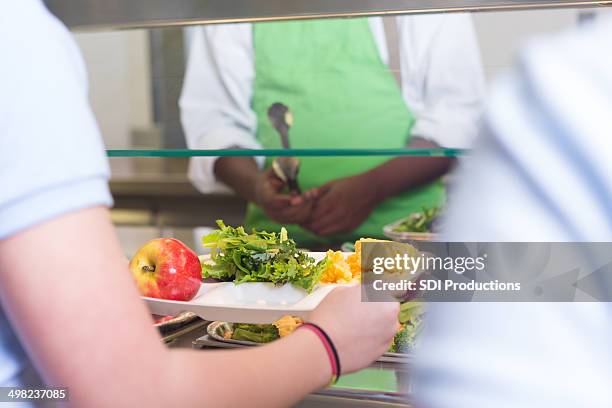 school students choosing variety of healthy foods in lunch line - school lunch stock pictures, royalty-free photos & images