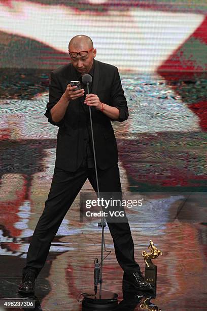 Director Guan Hu speaks on behalf of the Best Leading Actor Feng Xiaogang during the awards ceremony of the 52th Golden Horse Film Awards at National...