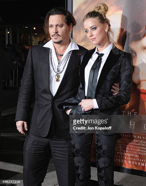 Actor Johnny Depp and wife actress Amber Heard arrive at the Los Angeles Premiere Of Focus Features' "The Danish Girl" at Westwood Village Theatre on...