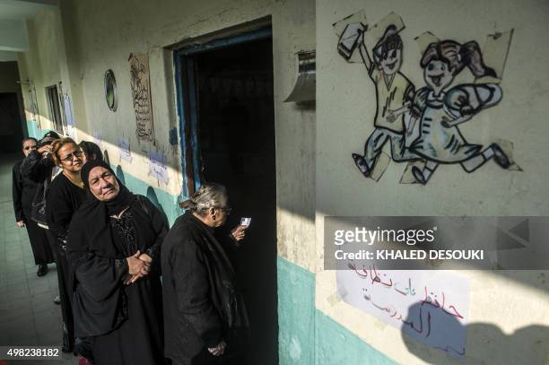 Egyptian women queue at a polling station in the capital Cairo on November 22 on the first day of the second and final round of the country's...