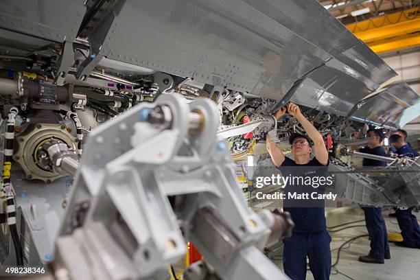 Skilled fitters work on the spoiler of a A400M at the Airbus aircraft manufacturer's Filton site on November 19, 2015 in Bristol, England. The site...