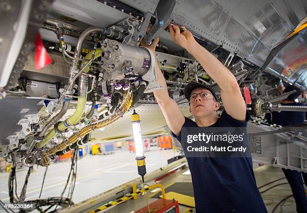 Skilled fitter works on the spoiler of a A400M at the Airbus aircraft manufacturer's Filton site on November 19, 2015 in Bristol, England. The site...