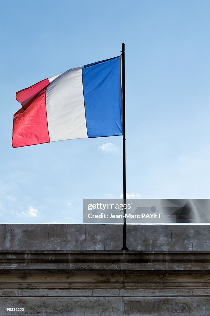 French tricolor flag floating in a blue sky