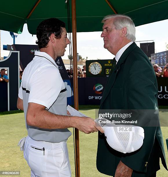 Rory McIlroy of Northern Ireland and Ivor Robson the offical starter of the European Tour meet for the last time on the first tee during the final...