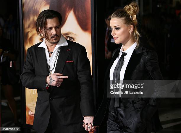 Amber Heard and Johnny Depp attend the premiere of Focus Features' 'The Danish Girl' on November 21, 2015 in Westwood, California.