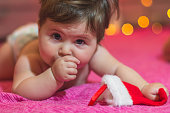 cute baby girl lying and waiting for gift