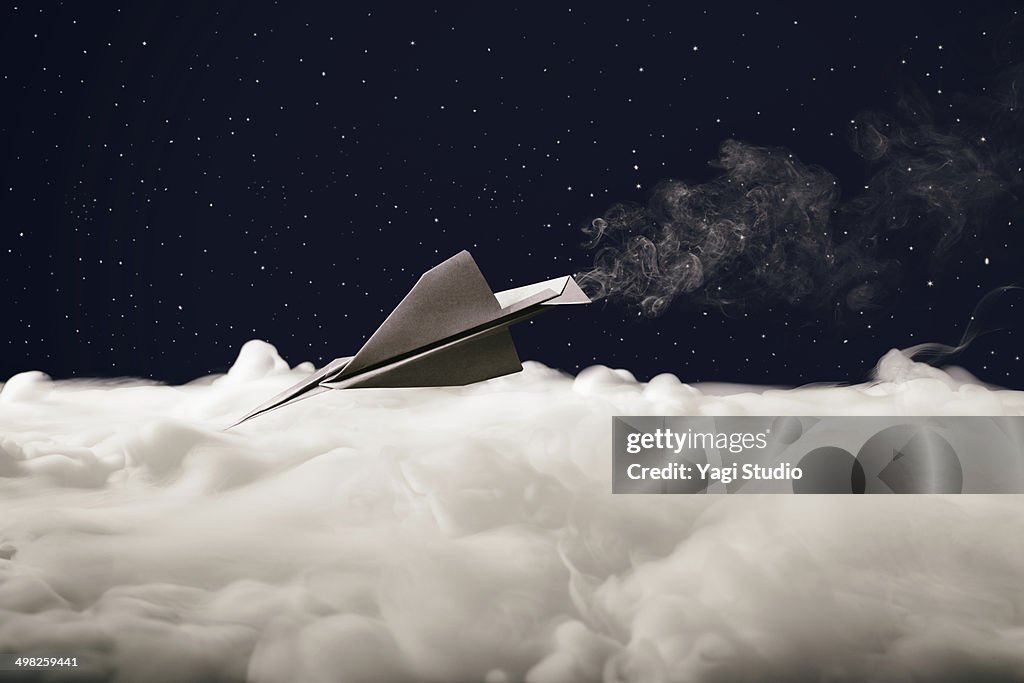 Paper airplane flying in the starry sky