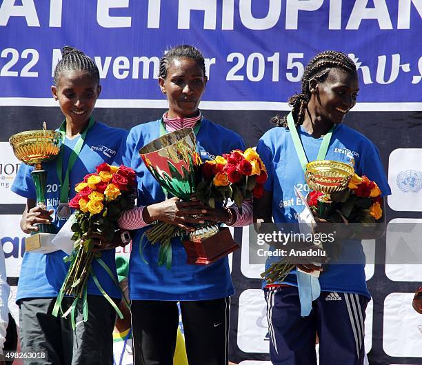 Ethiopian athletes Mamiu Desta comes in first position and gets the victory in the women's category, Yebirgual Melesse and Sule Tura hold trophies...