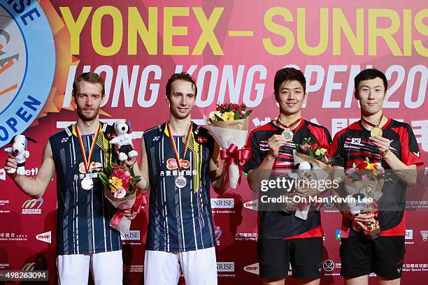 Carsten Mogensen, Mathias Boe, Lee Yong Dae, and Yoo Yeon-Seong pose for a picture with their medals after the match between Yoo Yeon Seong and Lee...