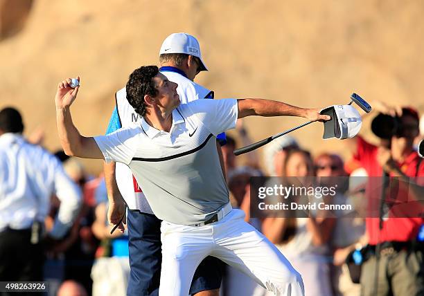 Rory McIlroy of Northern Ireland launches his ball to the crowd after holing his winning putt on the 18th green during the final round of the 2015 DP...
