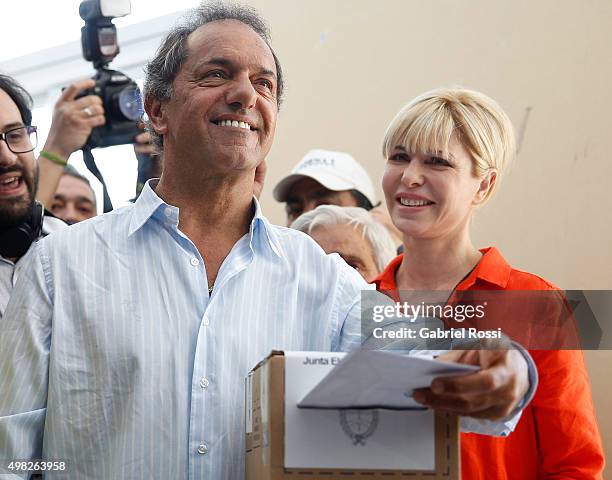 Daniel Scioli Presidential Candidate for Frente Para La Victoria joined by his wife Karina Rabolini casts his vote during runoff elections on...