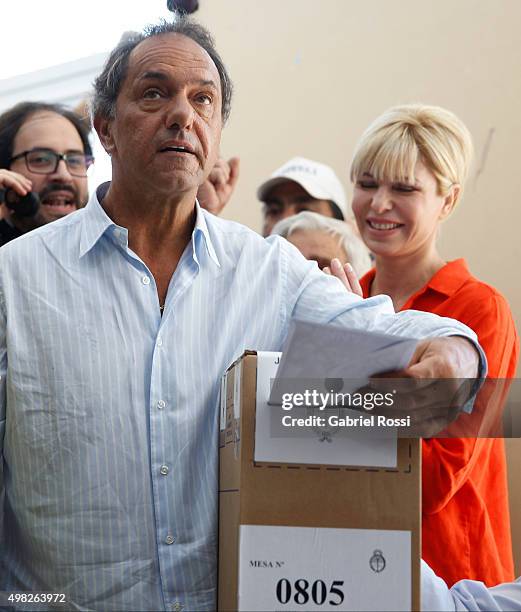 Daniel Scioli Presidential Candidate for Frente Para La Victoria joined by his wife Karina Rabolini casts his vote during runoff elections on...