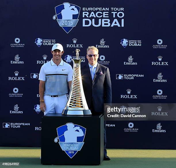 Rory McIlroy of Northern Ireland poses with Keith Pelley the Chief Executive of the European Tour and the Race to Dubai trophy after his one shot win...
