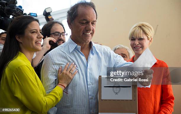 Daniel Scioli Presidential Candidate for Frente Para La Victoria joined by his daughter Lorena Scioli and his wife Karina Rabolini casts his vote...