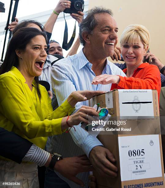 Daniel Scioli Presidential Candidate for Frente Para La Victoria joined by his daughter Lorena Scioli and his wife Karina Rabolini casts his vote...