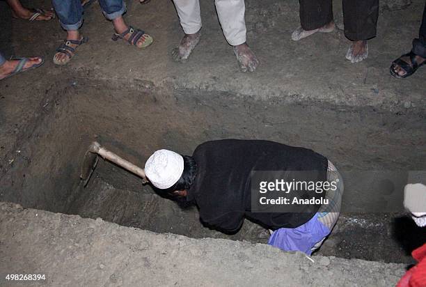 November 22: A man digs a grave during the Jamaat e Islamis Secretary General Ali Ahsan Muhammad Mujahid's burial ceremony near his ancestral home in...