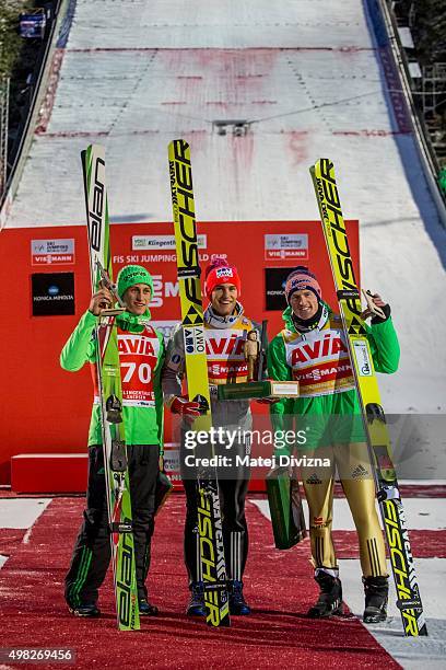 Peter Prevc of Slovenia, winner Daniel-Andre Tande of Norway and Severin Freund of Germany pose for photographers after the individual competition at...