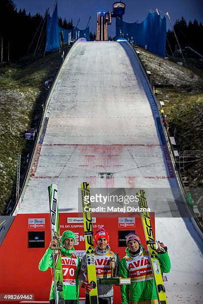 Peter Prevc of Slovenia, winner Daniel-Andre Tande of Norway and Severin Freund of Germany pose for photographers after the individual competition at...