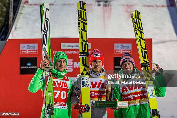 Peter Prevc of Slovenia, winner Daniel-Andre Tande of Norway and Severin Freund of Germany pose for photographers after the individual competition at...