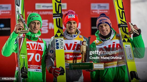 Peter Prevc of Slovenia, winner Daniel-Andre Tande of Norway and Severin Freund of Germany pose for photographers after the individual competition at...