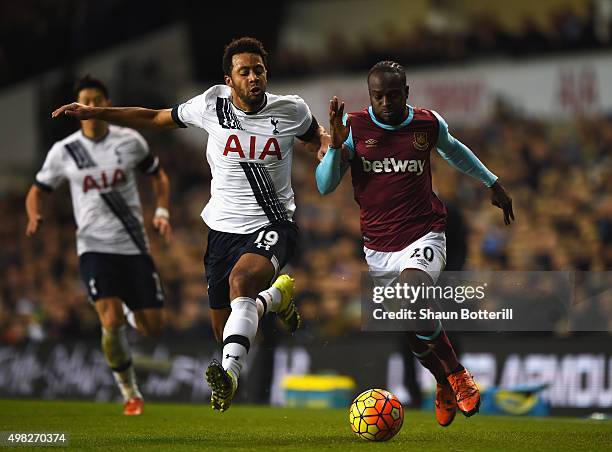 Mousa Dembele of Tottenham Hotspur is challenged by Victor Moses of West Ham United during the Barclays Premier League match between Tottenham...