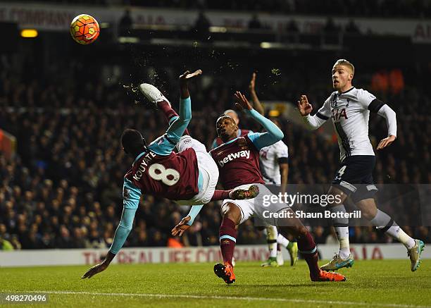 Cheikhou Kouyate of West Ham United performs an acrobatic shot on goal during the Barclays Premier League match between Tottenham Hotspur and West...