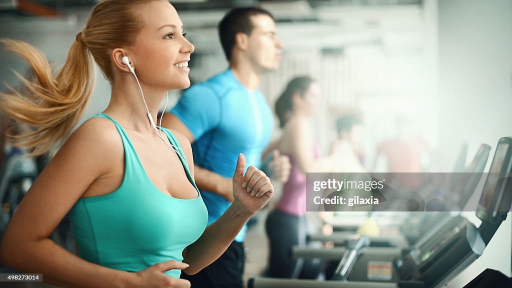 People doing treadmill exercise in a gym,