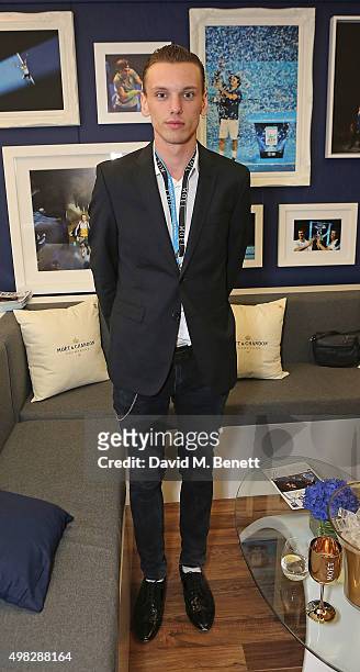Jamie Campbell Bower celebrates with Moet & Chandon whilst raising a toast to the winners of the 2015 Barclays ATP World Tour Finals at The O2 Arena...