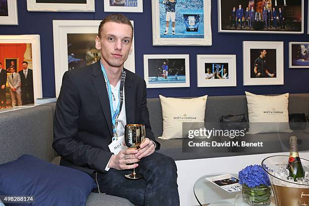 Jamie Campbell Bower celebrates with Moet & Chandon whilst raising a toast to the winners of the 2015 Barclays ATP World Tour Finals at The O2 Arena...