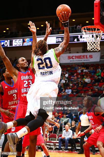 Cartier Martin of the Iowa Energy shoots the ball against Sam Thompson of the Grand Rapids Drive in an NBA D-League game on November 21, 2015 at the...