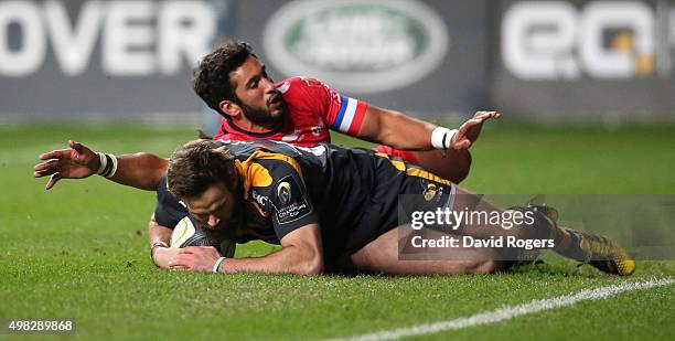 Ruaridh Jackson of Wasps breaks clear of Maxime Mermoz to score a try during the European Rugby Champions Cup match between Wasps and Toulon at the...