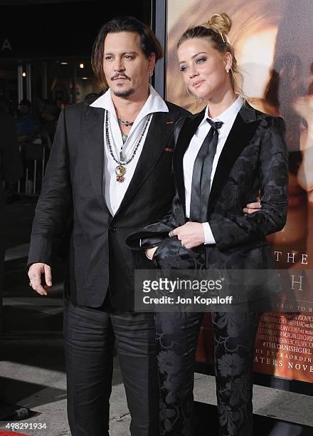 Actor Johnny Depp and wife actress Amber Heard arrive at the Los Angeles Premiere Of Focus Features' "The Danish Girl" at Westwood Village Theatre on...