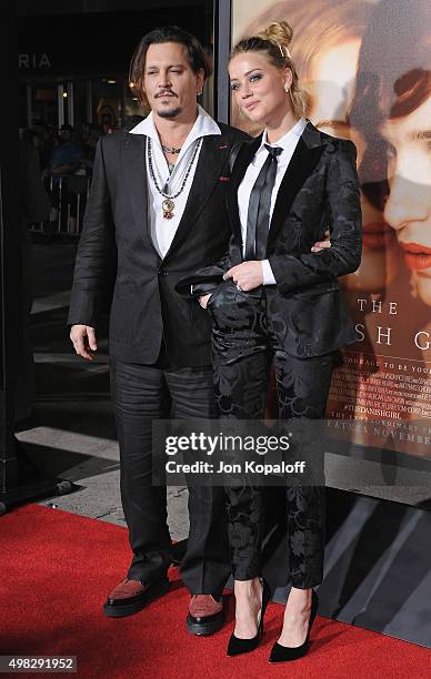 Actor Johnny Depp and wife actress Amber Heard arrive at the Los Angeles Premiere Of Focus Features' "The Danish Girl" at Westwood Village Theatre on...