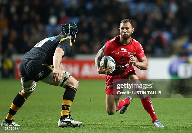 Toulon's fly-half from Australia Quade Cooper is closed down by Wasps' lock from England James Gaskell during the European Rugby Champions Cup rugby...