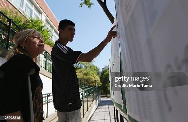 Voters check for their names at a polling station on November 22, 2015 in Buenos Aires, Argentina. Argentina is facing its first presidential...