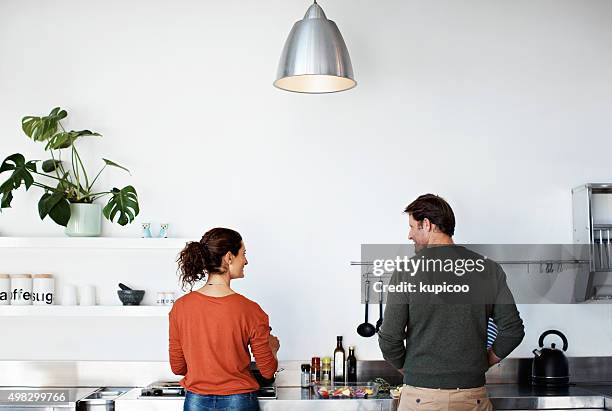 they love cooking together - couple in kitchen stock pictures, royalty-free photos & images