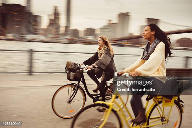 sharing a bicycle ride my friend in nyc - new york city bridge stock pictures, royalty-free photos & images