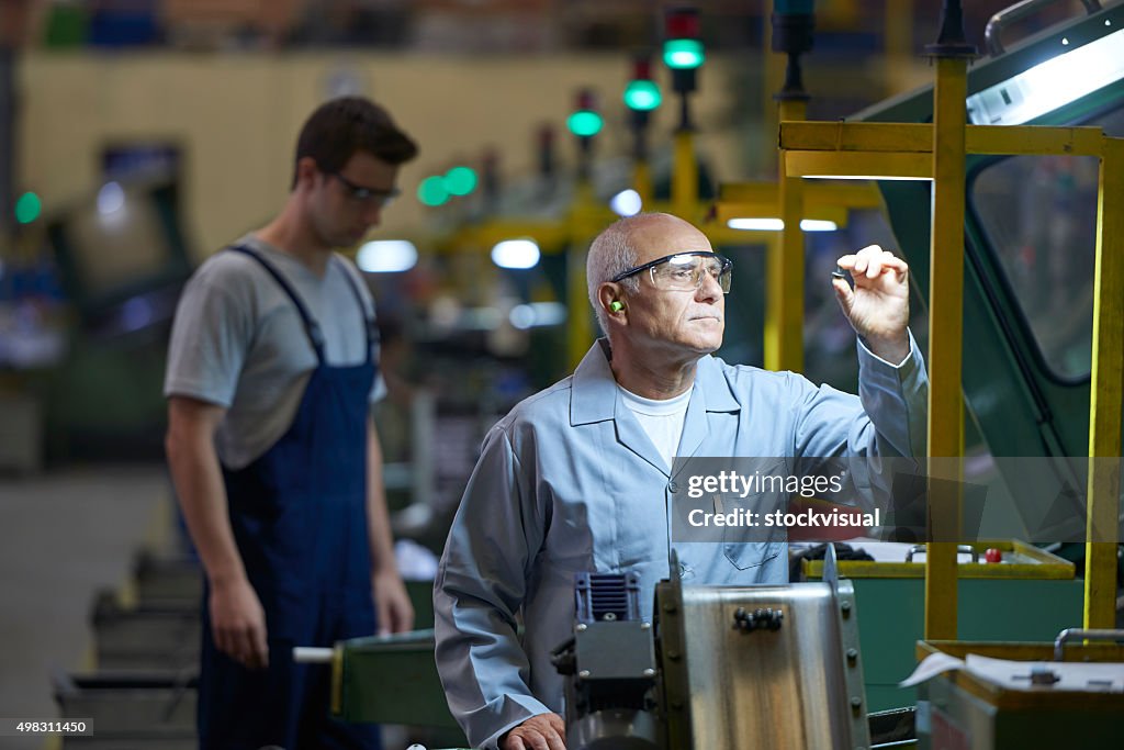 Worker looking at product in bolt factory