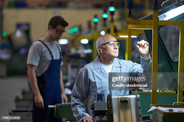 worker looking at product in bolt factory - efficiency stock pictures, royalty-free photos & images