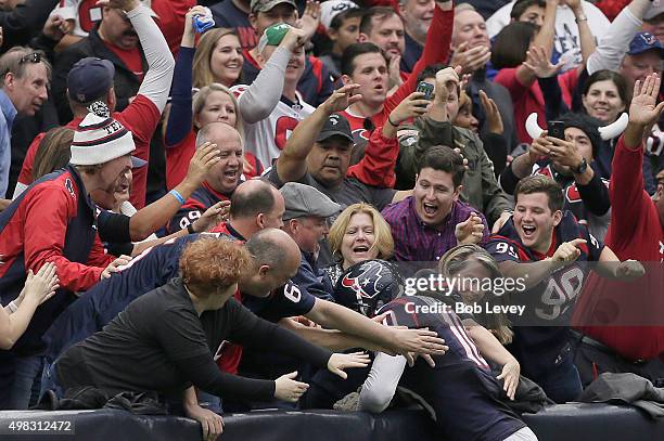 DeAndre Hopkins of the Houston Texans jumps in the stands after making a touchdown against the New York Jets in the second quarter on November 22,...