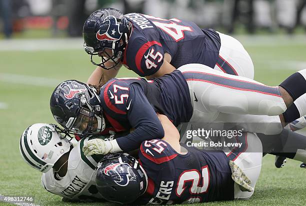 Jeremy Kerley of the New York Jets is gang tackled by Brian Peters , Justin Tuggle and Jay Prosch of the Houston Texans in the second quarter on...