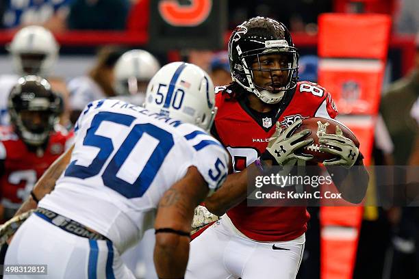 Roddy White of the Atlanta Falcons makes a catch against Jerrell Freeman of the Indianapolis colts during the first half at the Georgia Dome on...
