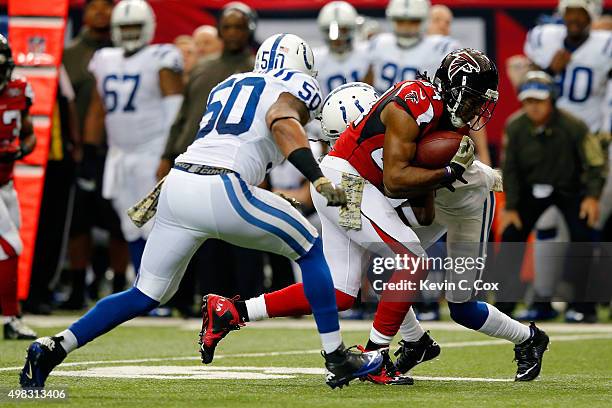 Roddy White of the Atlanta Falcons makes a reception against Greg Toler and Jerrell Freeman of the Indianapolis Colts during the first half at the...