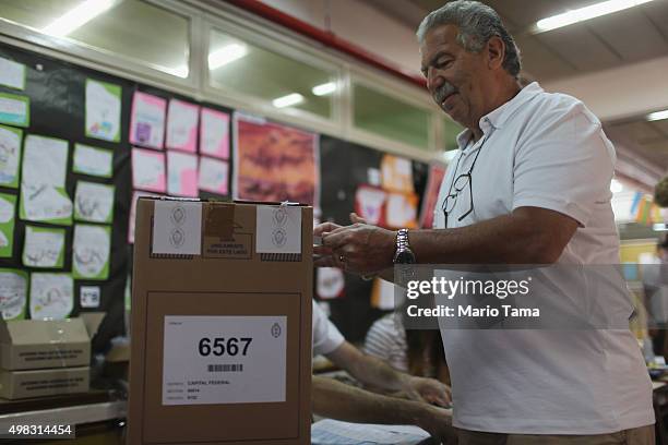 Voter casts his ballot at a polling station on November 22, 2015 in Buenos Aires, Argentina. Argentina is facing its first presidential election...