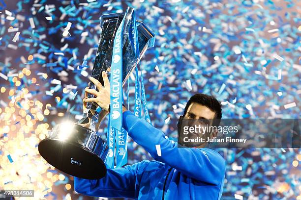 Novak Djokovic of Serbia lifts the trophy following his victory during the men's singles final against Roger Federer of Switzerland on day eight of...