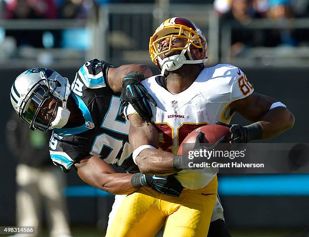 Bene' Benwikere of the Carolina Panthers defends a pass to Pierre Garcon of the Washington Redskins during their game at Bank of America Stadium on...